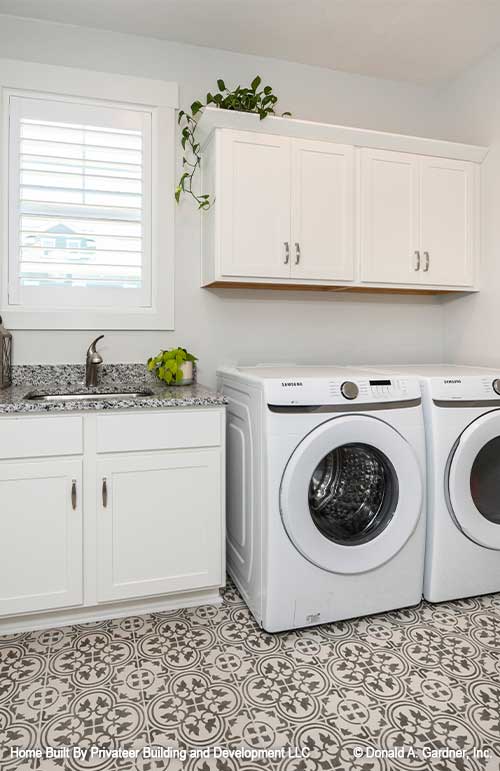 Laundry area beside a sink in the utility room. Percy plan 1503