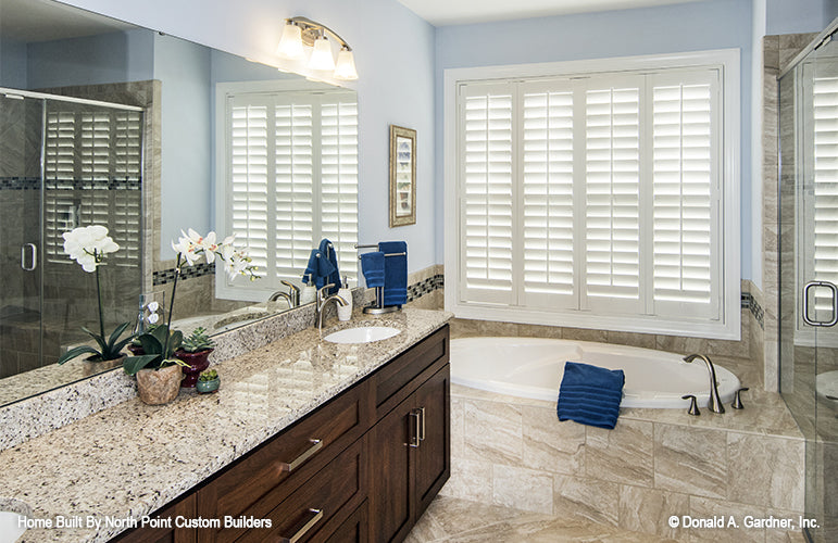 Soaking tub next to walk-in shower and vanity in the bathroom. The Peyton plan 1289.