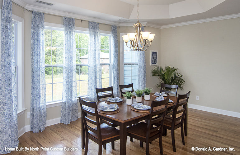 Well-lit dining room with five windows. The Peyton plan 1289.