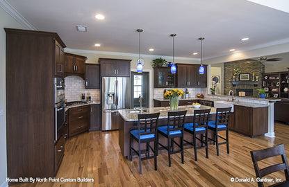 Seating at the island in the kitchen. The Peyton plan 1289.