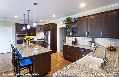 Three hanging pendant lights above the island in the kitchen. The Peyton plan 1289.