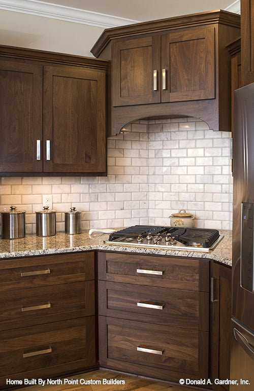 White subway tiles along the backsplash in the kitchen. The Peyton plan 1289.