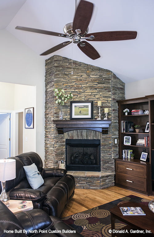 Floor to ceiling stone fireplace in the living room. The Peyton plan 1289.