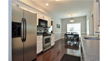 Flat ceiling and white cabinets in the kitchen. The Pinebluff plan 1036.