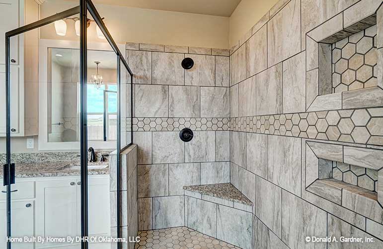 A large shower highlights the master bathroom in one story house plan 1316 The Primrose