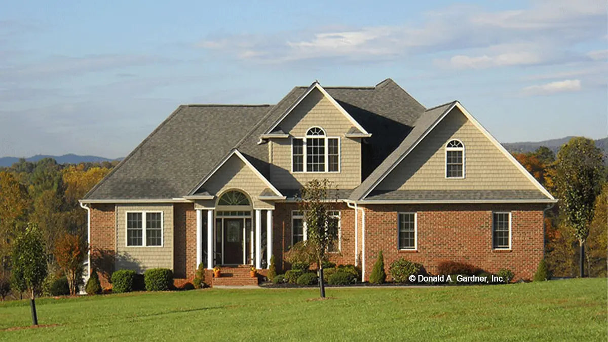 Photographs submitted by the customer. Front view photograph of a two-story brick home. The Radcliffe plan 799.