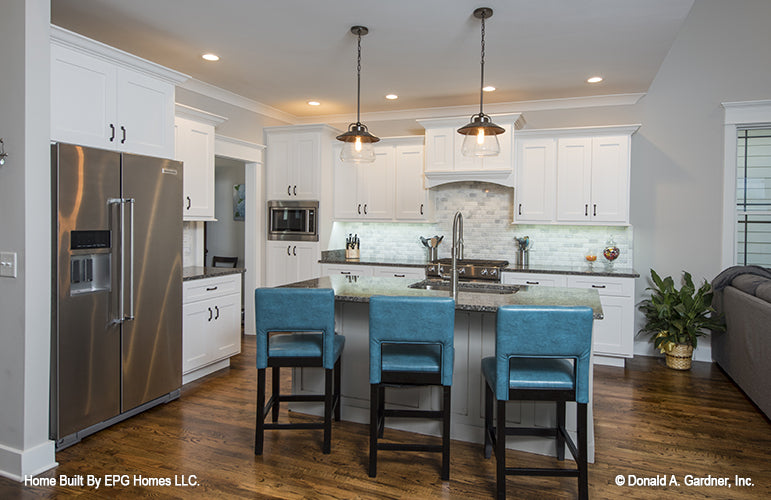 This is a picture of the kitchen and island of simple house plan 1108 The Radford