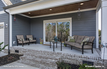 This is a picture of the rear porch and sitting area of simple house plan 1108 The Radford