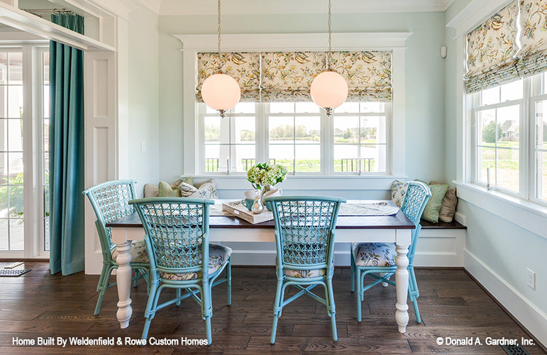 Wood floors and hanging pendant lights in the breakfast room. The Rangemoss plan 1211.