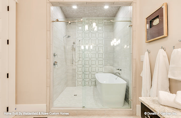 Bathtub within the walk-in shower in the master bathroom. The Rangemoss plan 1211.