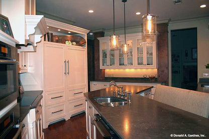 This is a kitchen picture showing island seating for one story house plan 1157 The Richelieu