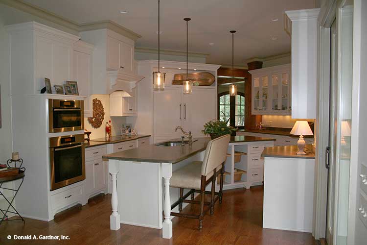 This kitchen picture shows double oven and island view for one story house plan 1157 The Richelieu