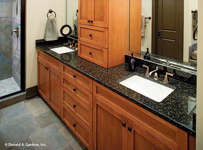 Double sink vanity separated by cabinet in the master bathroom. The Riva Ridge plan 5013.