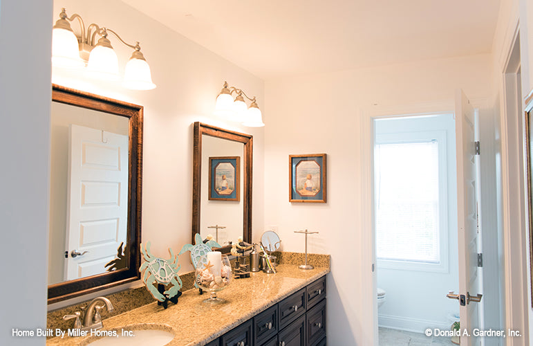 This is a picture of the upstairs bath with large vanity and toilet room for Riverbend house plan 225