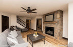 A fireplace and sitting area added in the basement family room of The Roark Plan 1406