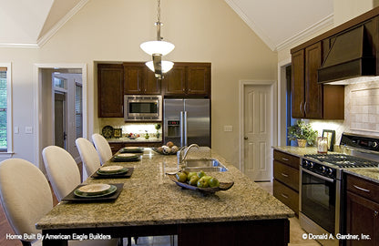 This is a kitchen with island seating picture of five bedroom house plan 1204 The Rochelle