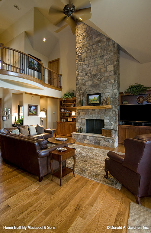 Stone fireplace and second story ceiling in the great room. The Rockledge plan 875.