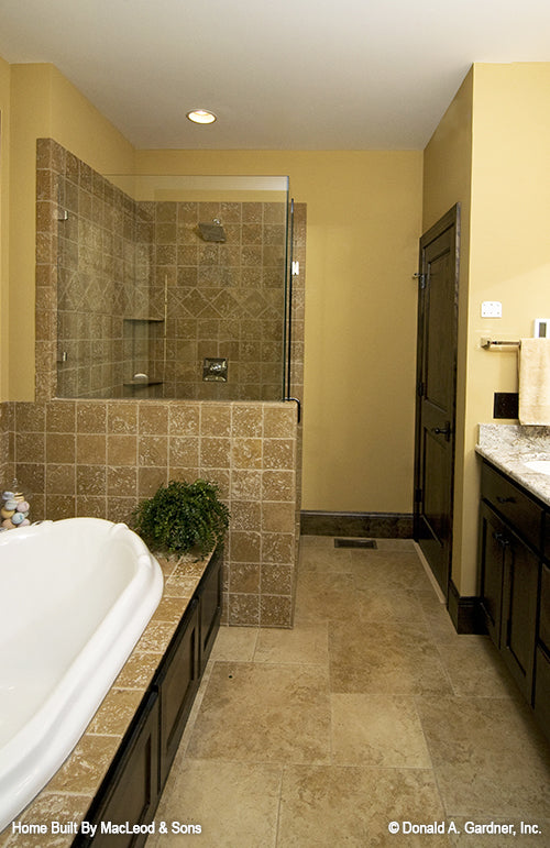 Sitting tub beside the walk-in shower in the master bedroom. The Rockledge plan 875.