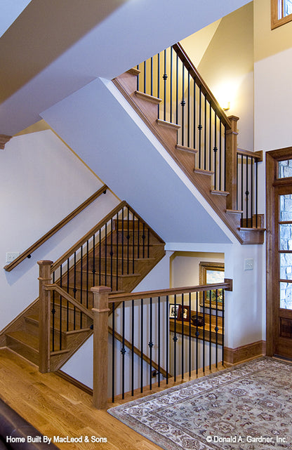 Stained wood stairs with black spindles. The Rockledge plan 875.