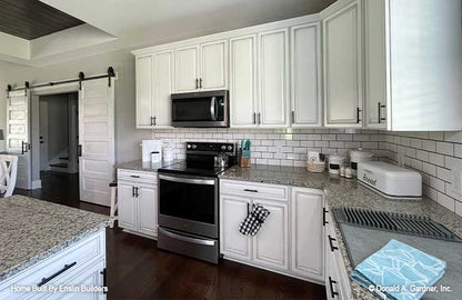 Subway tile and plenty of cabinet space in the kitchen. The Rogers plan 1383. 