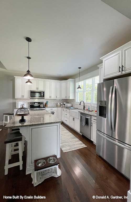 Full kitchen view with stainless-steel appliances. The Rogers plan 1383. 