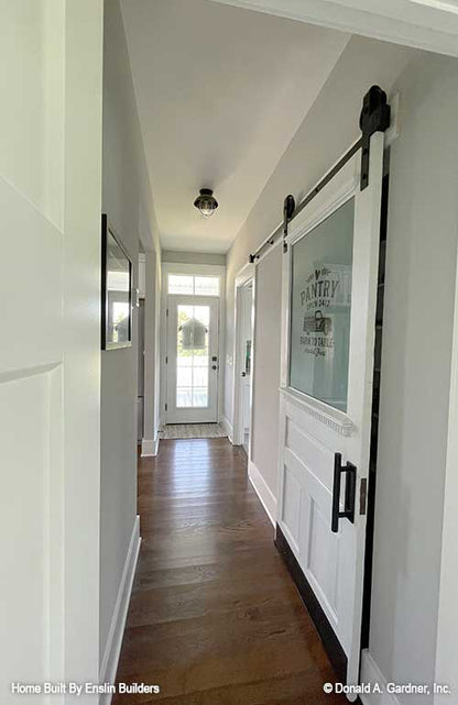 Sliding farmhouse style door to the pantry. The Rogers plan 1383. 