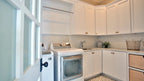 Plenty of storage and counter space in the utility room in European house plan 1378 The Roseburg