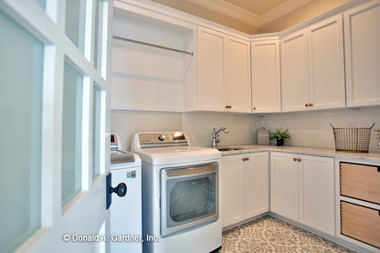 Plenty of storage and counter space in the utility room in European house plan 1378 The Roseburg