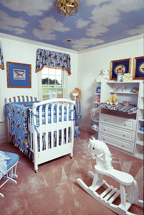 Secondary bedroom made into a nursery with clouds on the ceiling. The Rousseau plan 451.