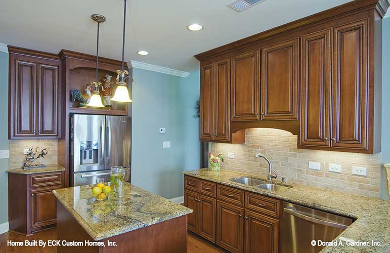 Recessed lighting and island in the kitchen. The Rowan plan 1366. 