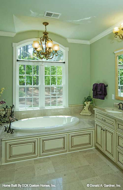 Sitting tub with windows above in the master bathroom. The Rowan plan 1366. 