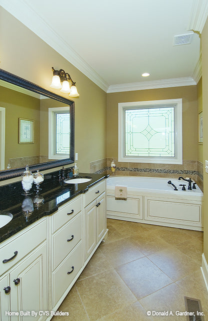 Double sink vanity with sitting tub off to the side in the bathroom. The Runnymeade plan 1164.