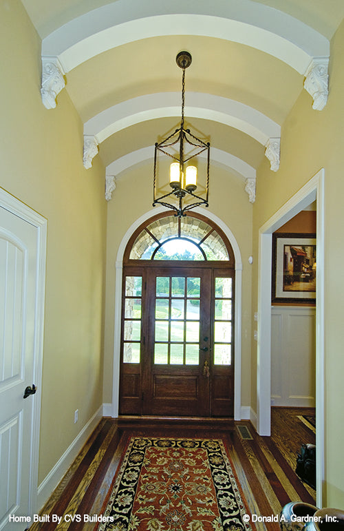 Elegant arched ceilings and beams in the foyer. The Runnymeade plan 1164.