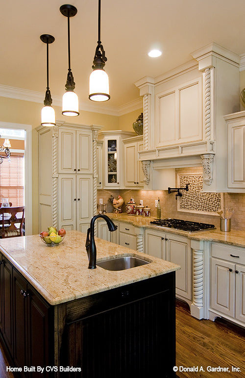 Island view of the kitchen with the countertop stove. The Runnymeade plan 1164.