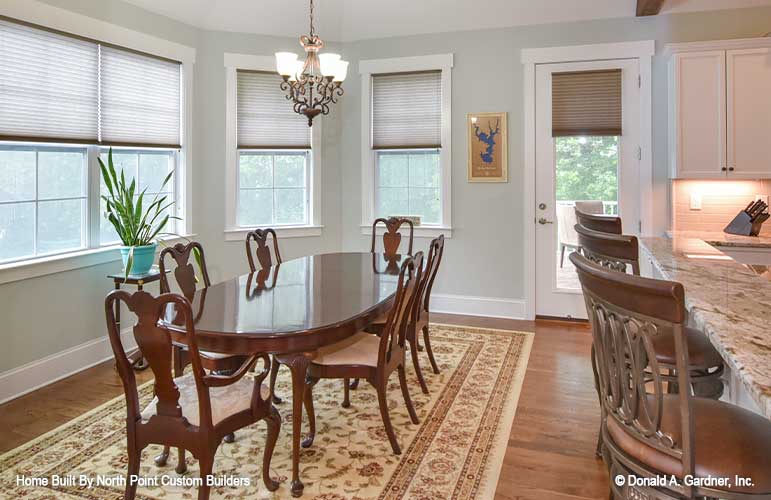 An open dining room gives space for both formal and casual dining for Craftsman house plan 1329 The Sandy Creek