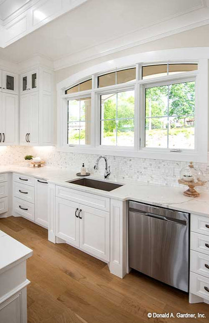 The kitchen sink provides views to the front of Executive house plan 1403 The Sarafine