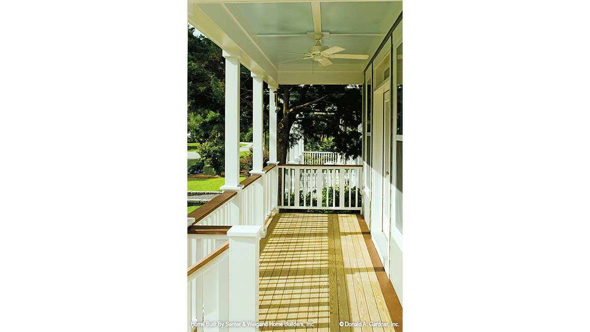 Covered front porch with a ceiling fan. The Sassafras plan 814.