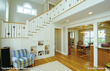 Built-in storage and shelved under the staircase in the great room. The Sassafras plan 814.