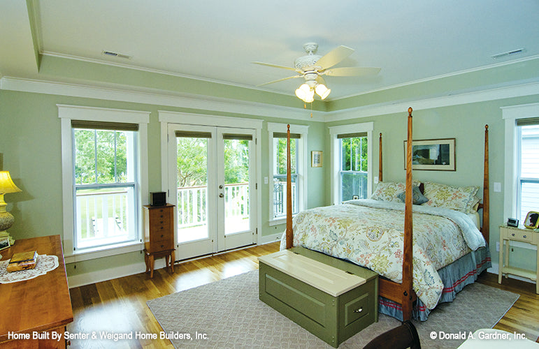 Tray ceiling and glass patio doors in the master bedroom. The Sassafras plan 814.