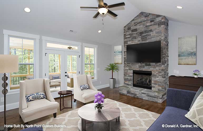 Great room view of the stone fireplace and French doors leading to porch. The Satchwell plan 967