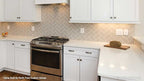 All white cabinets in the kitchen with Harring bow backsplash. The Satchwell plan 967