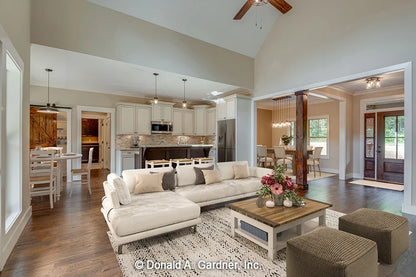 The great room is the primary gathering and entertainment space for small house plan 1422 The Sawyer