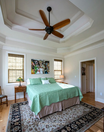 The expansive master bedroom features an elaborate tray ceiling and lots of windows