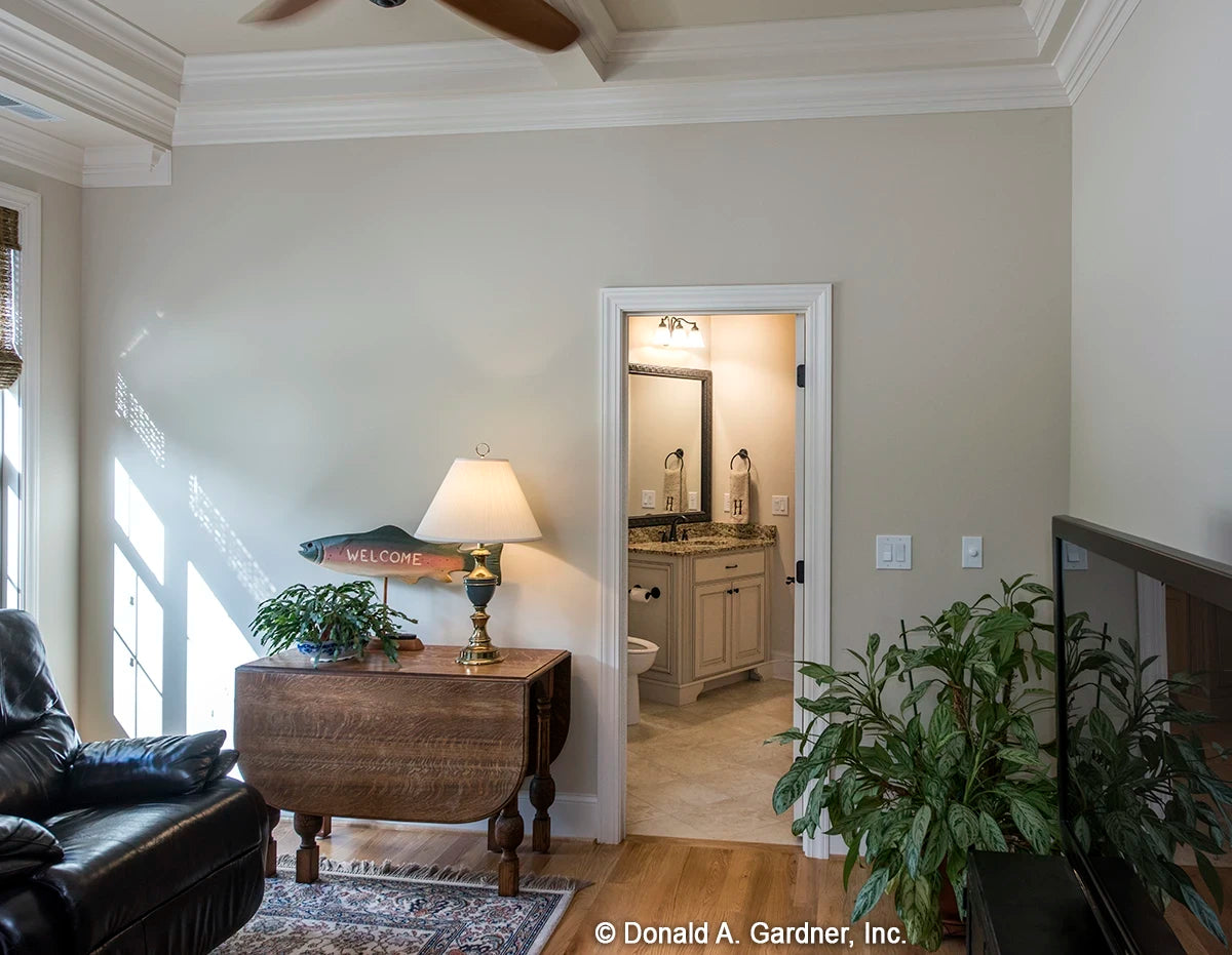 Bonus room featuring a coffered ceiling and doorway to bathroom.