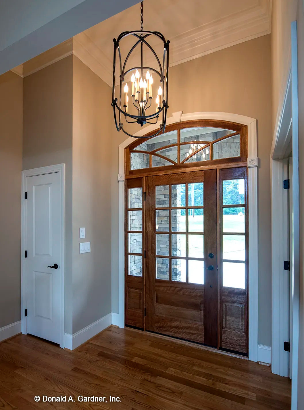 Foyer with large arched topped front door