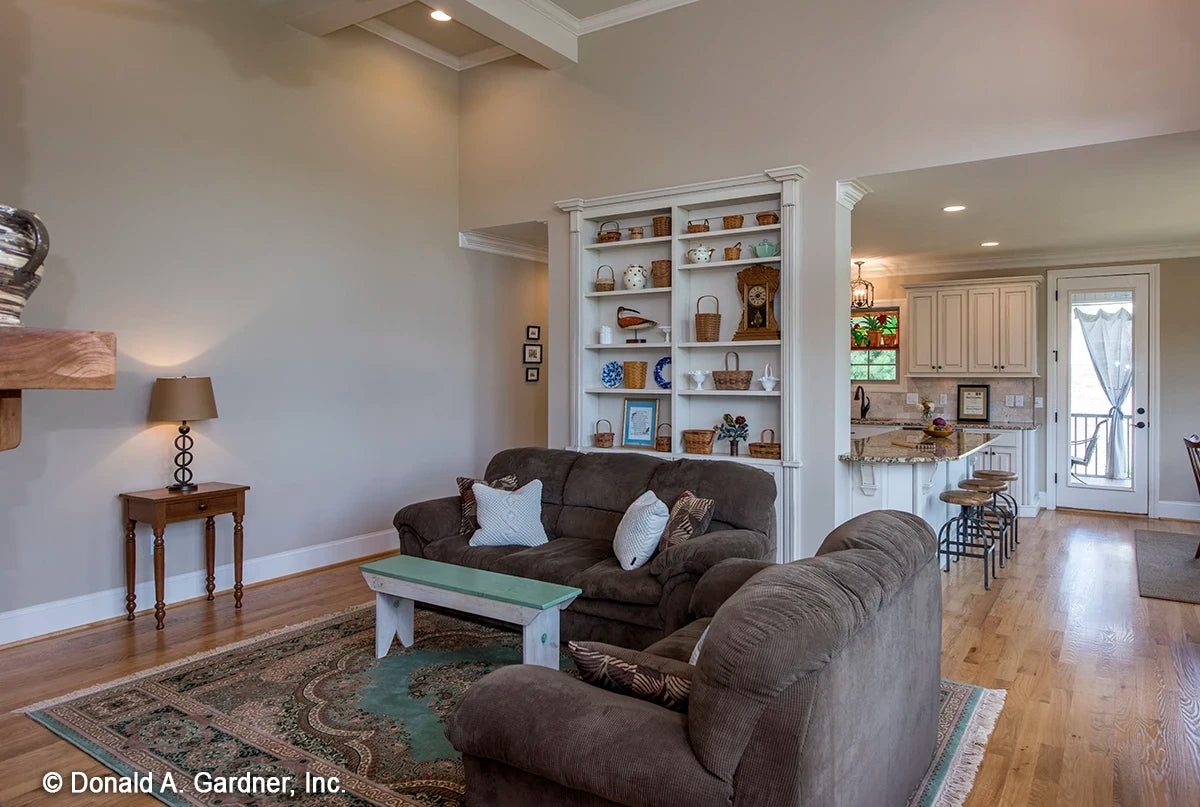 Built-in cabinets and shelves act as a separation between the great room and the kitchen