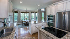 The kitchen features granite counter tops and is connected to the breakfast nook