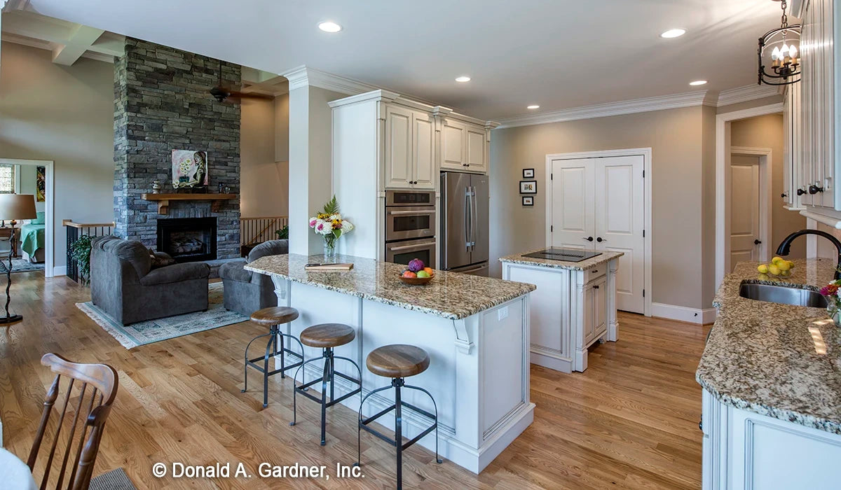 The view from the breakfast nook takes in the stone fireplace and the kitchen