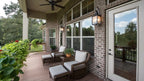 The covered back porch shows the large windows into the great room