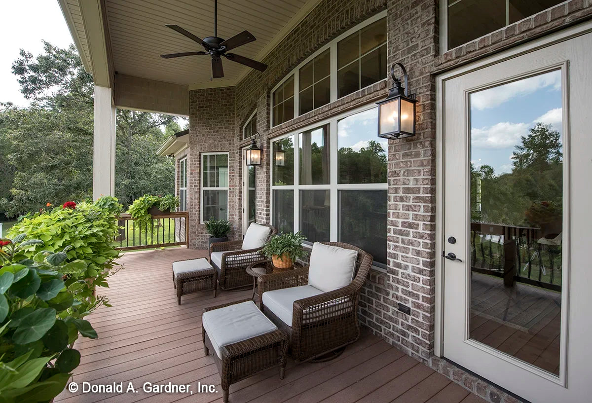 The covered back porch shows the large windows into the great room